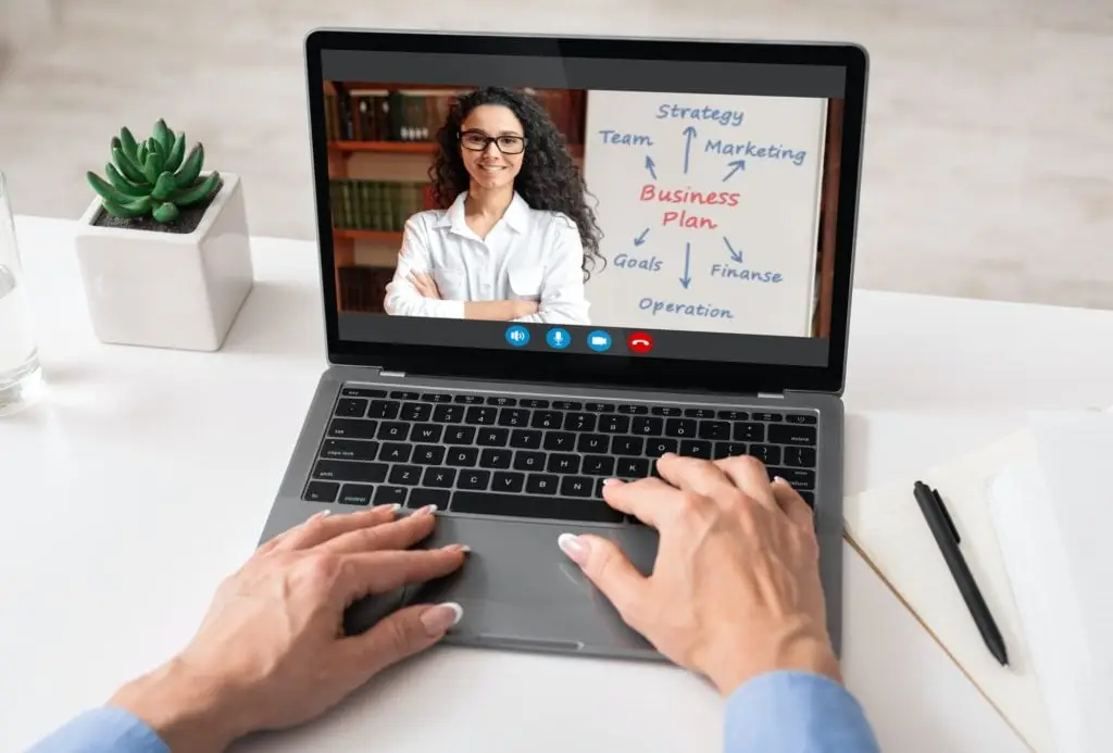 Unrecognizable woman having video call with business coach, using laptop